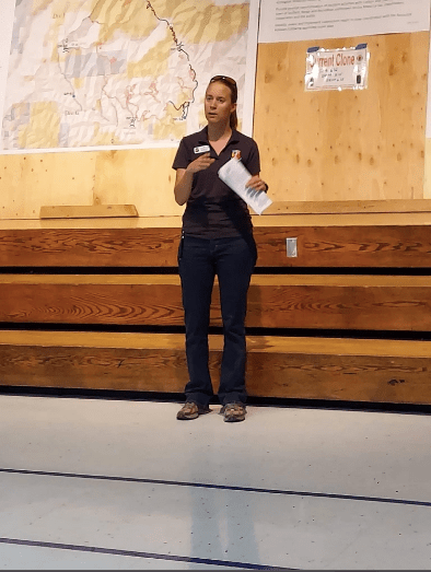 Julie Malingowski provides a briefing to fire crews as an Incident Meteorologist in the field covering the weather impacts on a wildfire. She provides weather information to help leaders plan long-term resource needs of combatting large wildfires. (Photo courtesy of Julie Malingowski)