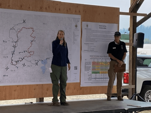 Julie Malingowski provides a briefing to fire crews as an Incident Meteorologist in the field covering the weather impacts on a wildfire. She provides weather information to help leaders plan long-term resource needs of combatting large wildfires. (Photo courtesy of Julie Malingowski)